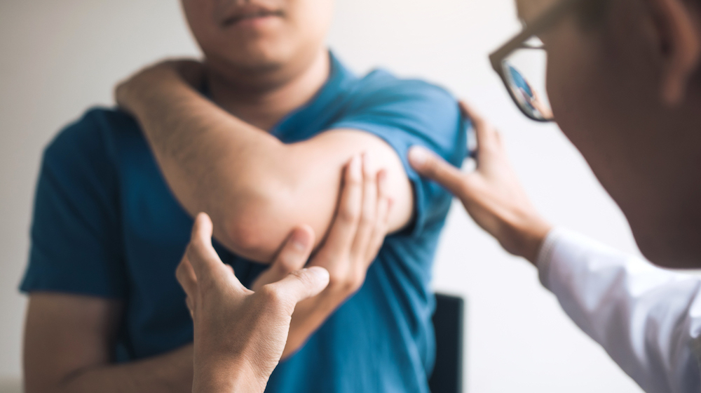 Physical therapists are checking patients elbows at the clinic office room.